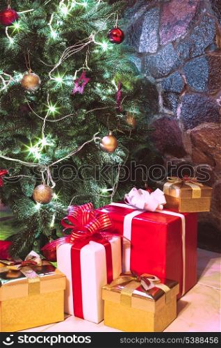 Presents boxes under the Christmas tree. Gold, red and white colours