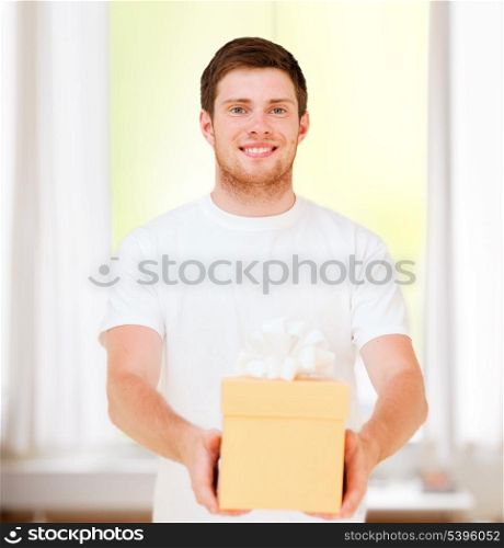 presents, gifts, post delivery and celebration - man in white t-shirt with gift box