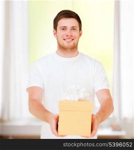 presents, gifts, post delivery and celebration - man in white t-shirt with gift box