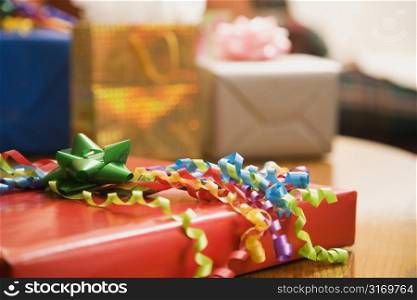 Presents wrapped and decorated with bows on a table.