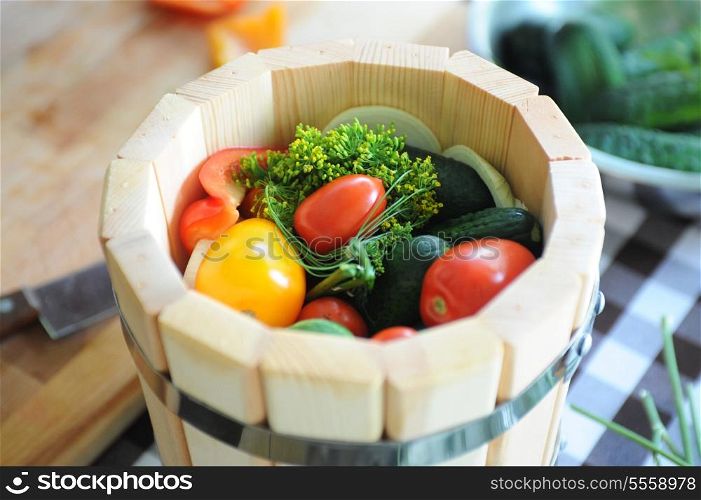 preserved tomatoes, cucumbers, peppers in wooden jar