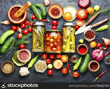 Preserves vegetables in glass jars.Various canned vegetables.Marinated food.. Assortment of pickled vegetable