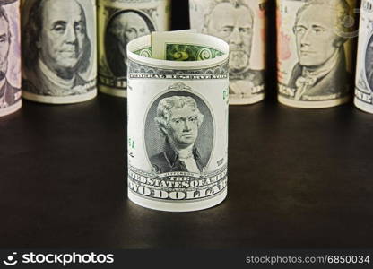 President with bills two dollars on a background of presidents from other denominations