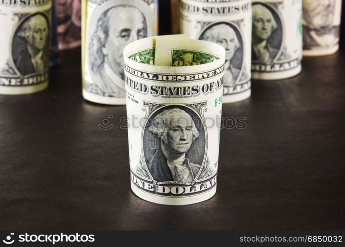 President with one dollar banknotes on a background of presidents from other denominations