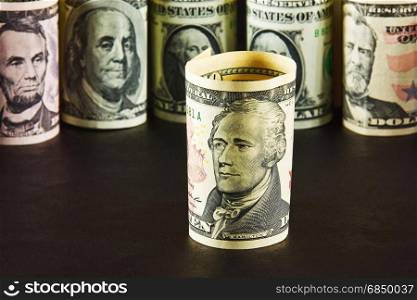 President with ten dollar bills on a background of presidents from other denominations