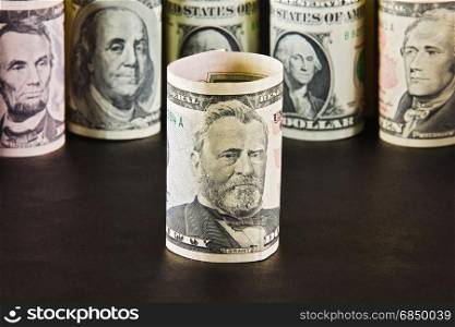President with ten dollar bills on a background of presidents from other denominations
