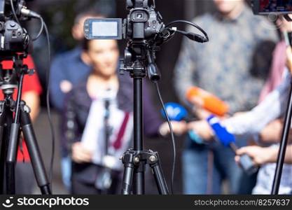 Press conference. Filming media or news event with video or television camera.