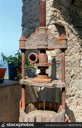Press wine. The old device for the production of wine. Traditional press for making wine from the grapes in Liguria. Italy.