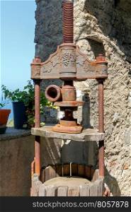 Press wine. The old device for the production of wine. Traditional press for making wine from the grapes in Liguria. Italy.
