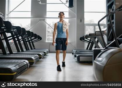 Preteen boy wearing sportswear visiting treadmill hall at gym. Sport and active hobby recreation for children concept. Preteen boy wearing sportswear visiting treadmill hall at gym