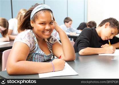 Pretty African-American girl in diverse middle school class.