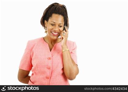 Pretty african-american woman talking on her mobile phone. Isolated on white.