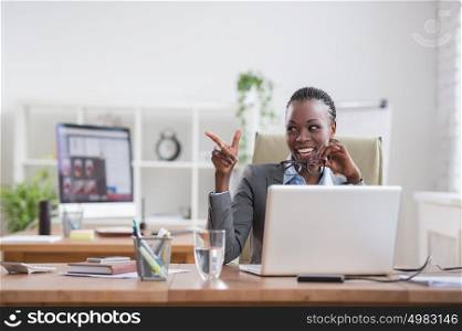 Pretty african business woman having fun at office