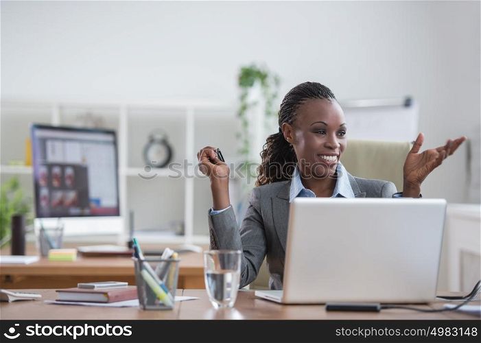 Pretty african business woman having fun at office