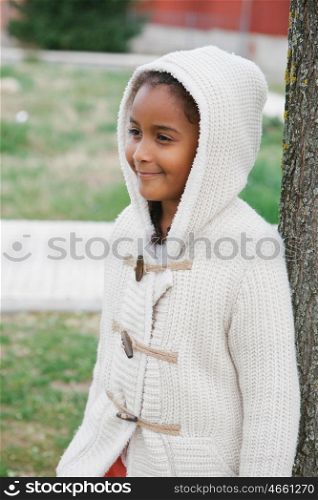 Pretty african girl with winter clothes in the park