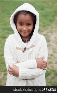 Pretty african girl with winter clothes in the park