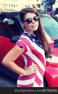 Pretty American girl in American flag t-shirt. Portrait outdoors
