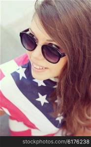 Pretty American girl in American flag t-shirt. Portrait outdoors