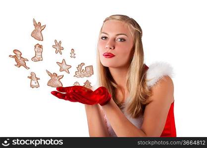pretty and sensual blond girl in santa claus red dress posing a smiling with a nice hairstyle blowing cookies