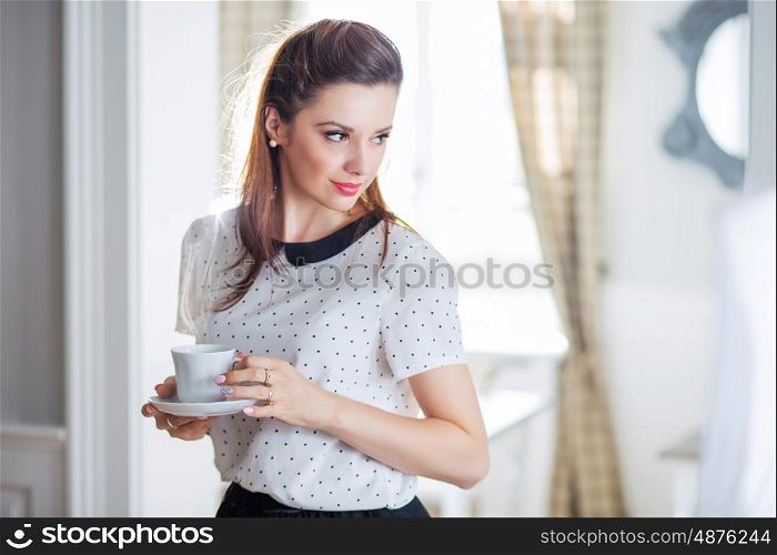 Pretty and smart lady drinking coffee