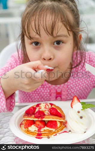 Pretty Asian Girl Eating a Strwaberry Waffle with ice cream