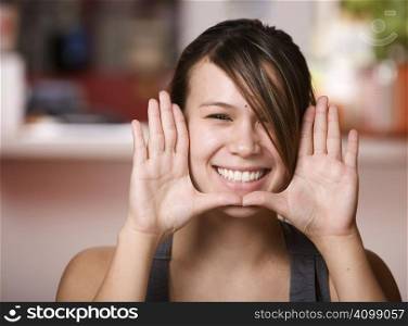 Pretty Asian Woman Framing Face with her Hands