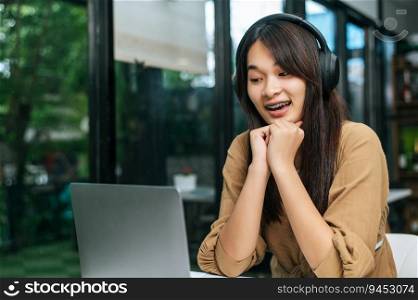 Pretty asian woman sitting and enjoy to listening musice from wireless headphone and singing together with smartphone at cafe, relaxing and lifestyle concept.