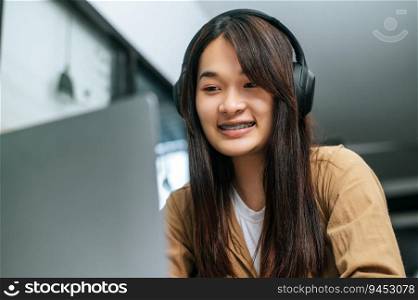 Pretty asian woman sitting and enjoy to listening musice from wireless headphone and singing together with smartphone at cafe, relaxing and lifestyle concept.
