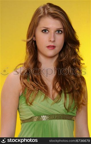 Pretty auburn haired teenager in a green dress