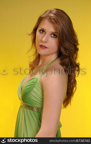 Pretty auburn haired teenager in a green dress