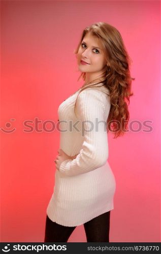 Pretty auburn haired teenager in a white sweater