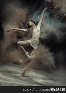 Pretty ballet dancer with dust in the background