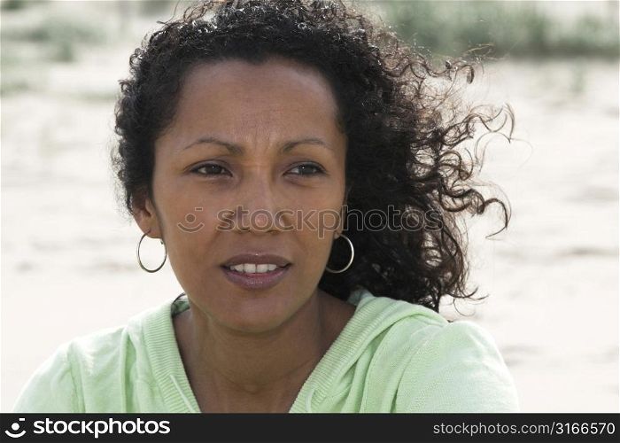 Pretty black woman squinting a bit against the bright sunlight