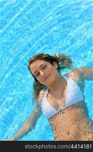 Pretty blond girl in a swimming pool