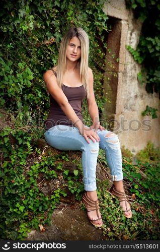 Pretty blond girl outdoors posing for a photo