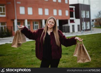 Pretty blond girl with fur coat shopping