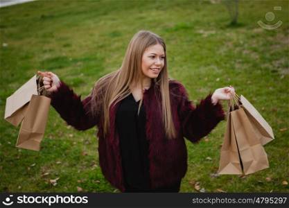 Pretty blond girl with fur coat shopping