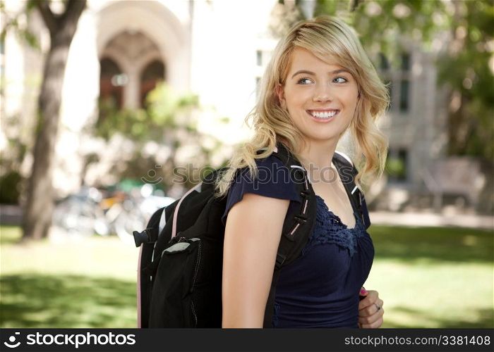 Pretty blond university student looking over shoulder