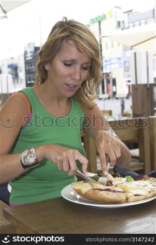 Pretty blond woman getting a tasty toasted sandwich
