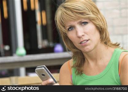 Pretty blond woman looking slightly irritated