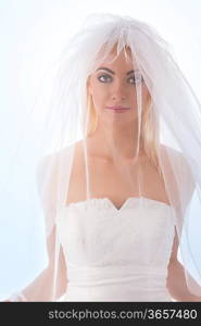 pretty blonde girl dressing as bride with white veil over face, blonde smooth hair looks in camera