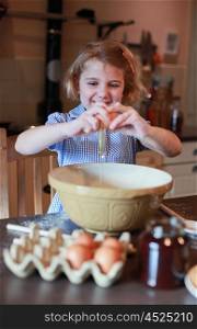 Pretty blonde girl haired cracking an egg into a mixing bowl