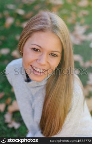 Pretty blonde girl in the park at autumn
