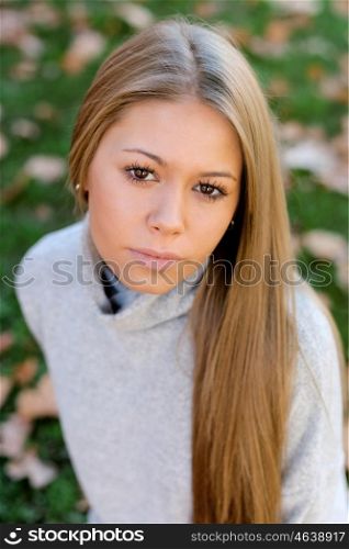 Pretty blonde girl in the park at autumn