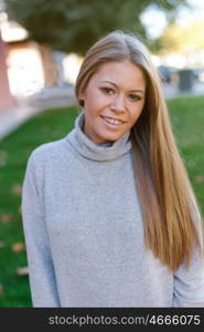 Pretty blonde girl in the park at autumn