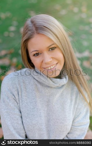 Pretty blonde girl in the park at autumn