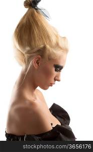 pretty blonde girl with creative dark make-up and upward hairstyle, she is turned in profile at left and looks down