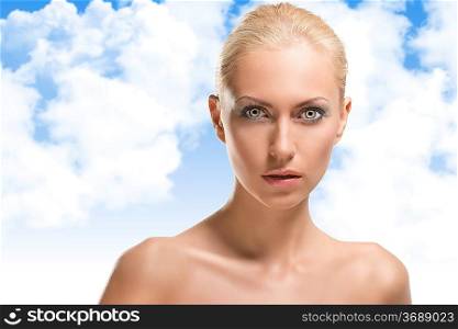 pretty blonde girl with naked shoulders, she is in front of the camera, looks in to the lens with expression of surpraise