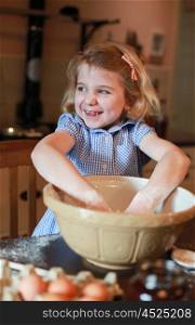 Pretty blonde haired girl baking wearing checked dress
