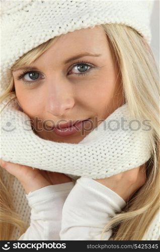 Pretty blonde in a cream knitted hat and scarf